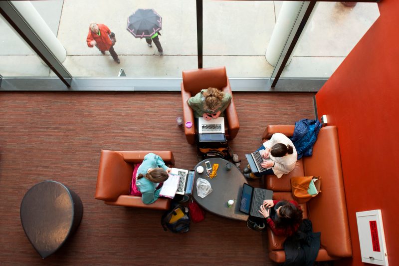 View from above of a group of people working together on laptops